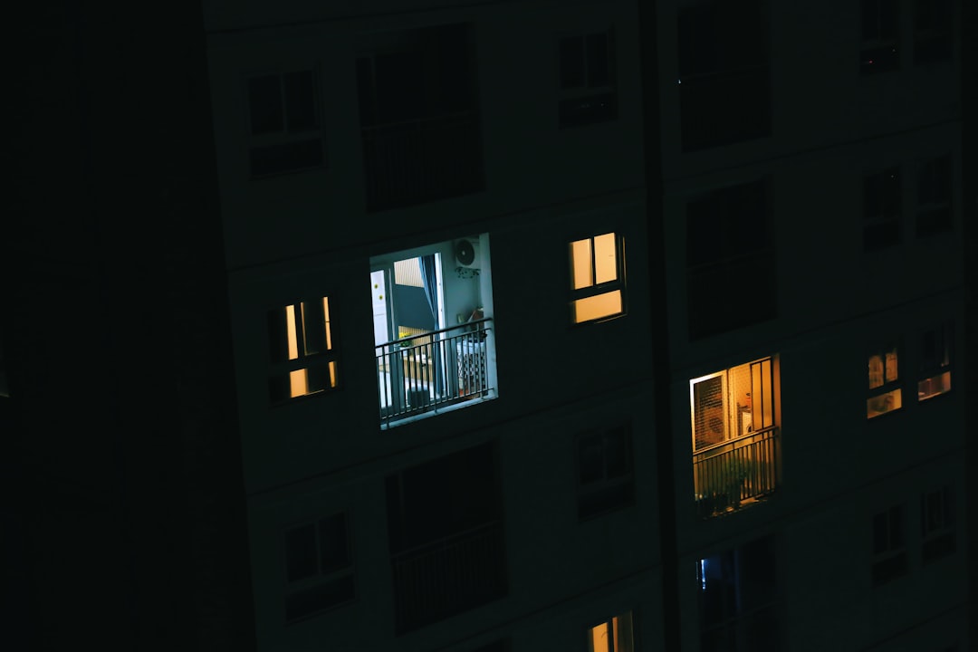 a view of a building at night from a balcony