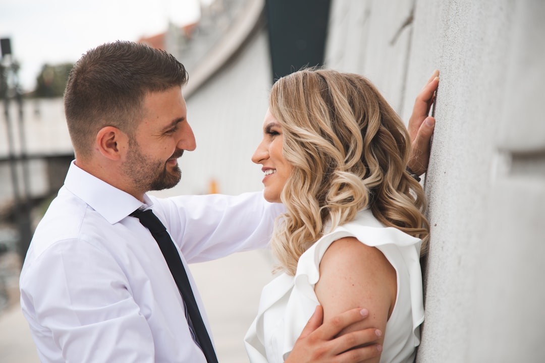 A couple smiling at each other outdoors