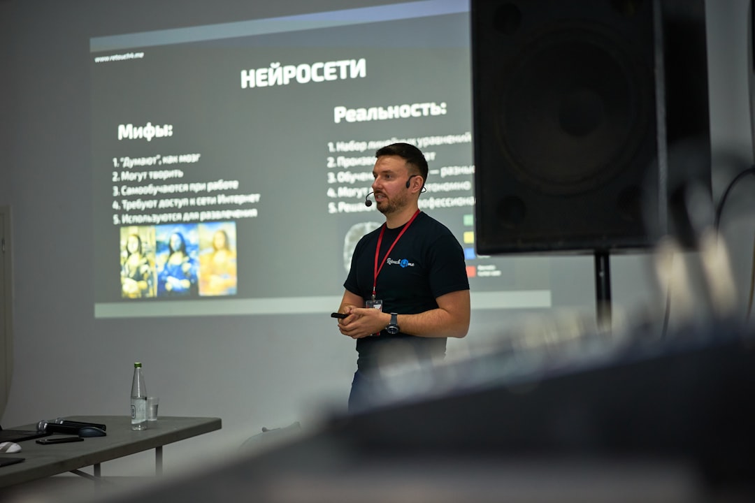A man standing in front of a projector screen