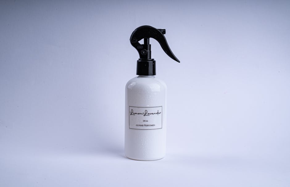 Elegant minimalist perfume spray bottle with unique lever on a clean white backdrop, ideal for product design.