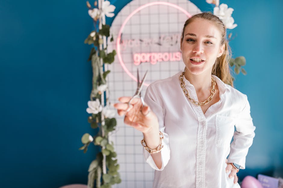 Woman in white shirt holding scissors in trendy indoor setup with neon sign.