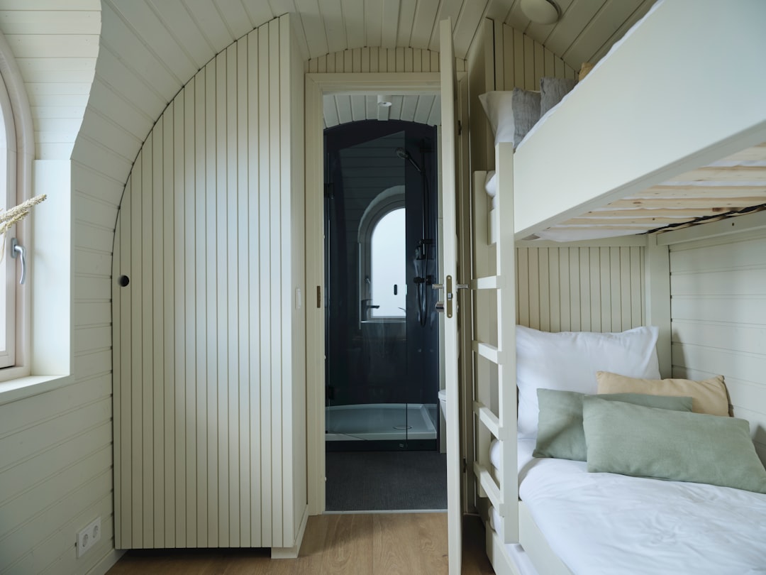 A room with bunk beds and a window