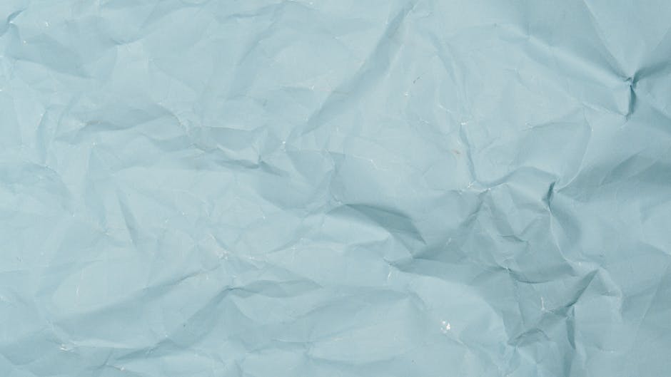 Detailed crumpled blue paper background perfect for design projects needing textured material.
