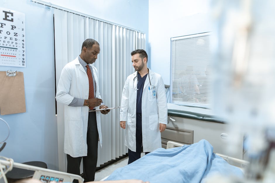 Two doctors review a patient's chart in a hospital room, focusing on healthcare cooperation and medical care.