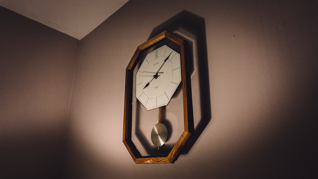 brown wooden framed analog wall clock