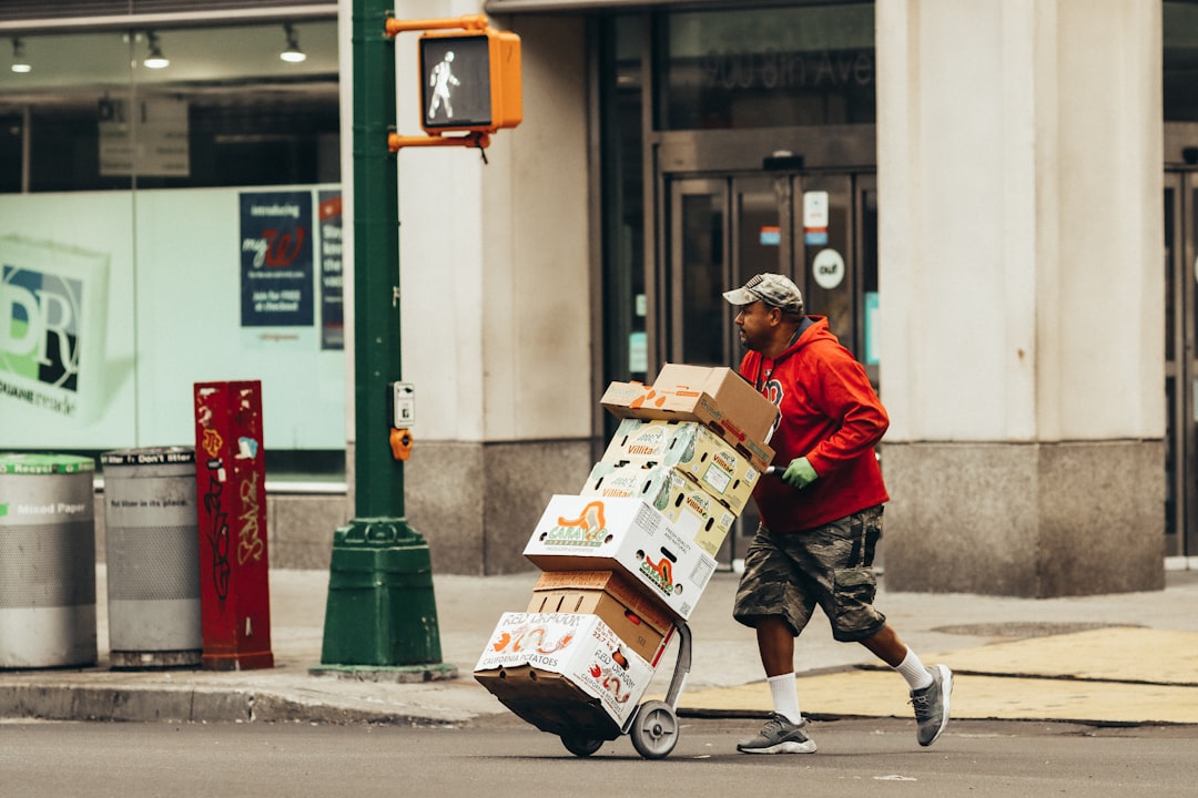 a man pushing a cart full of boxes