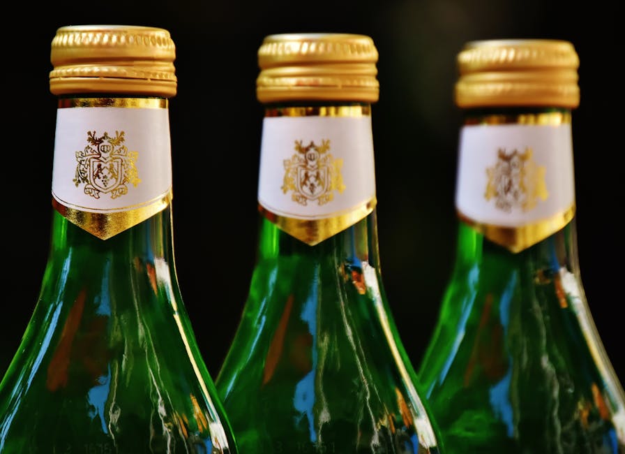 Three green glass bottles topped with gold lids, perfect for celebration imagery.