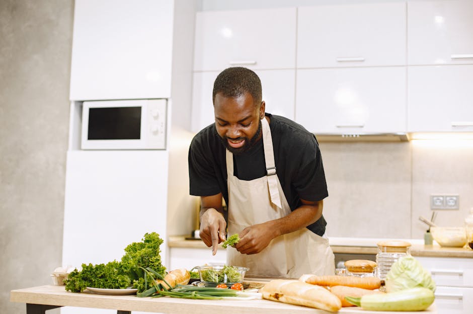 A chef in a kitchen preparing a fresh salad with vegetables, showcasing culinary skills.