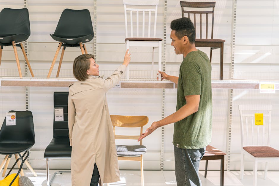 A couple explores chair options together in a modern furniture store during the day.