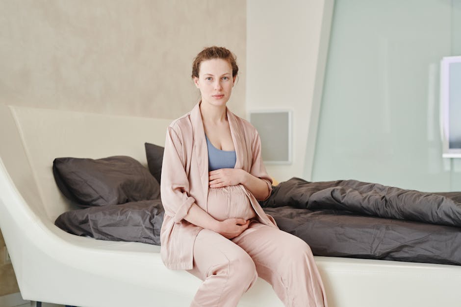 A serene image of a pregnant woman sitting on a bed, embracing motherhood in a modern bedroom setting.