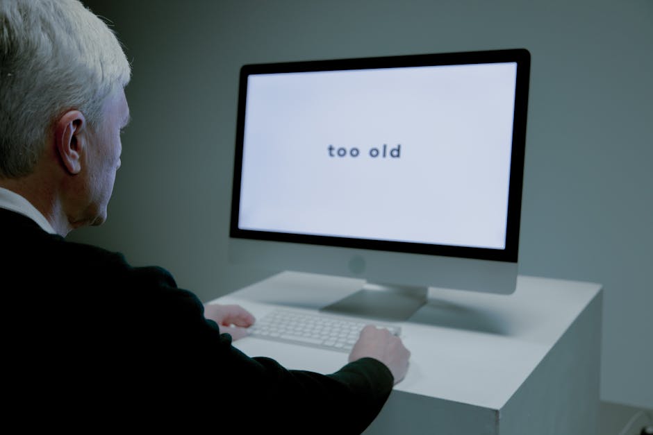 Senior man at computer facing ageism online,