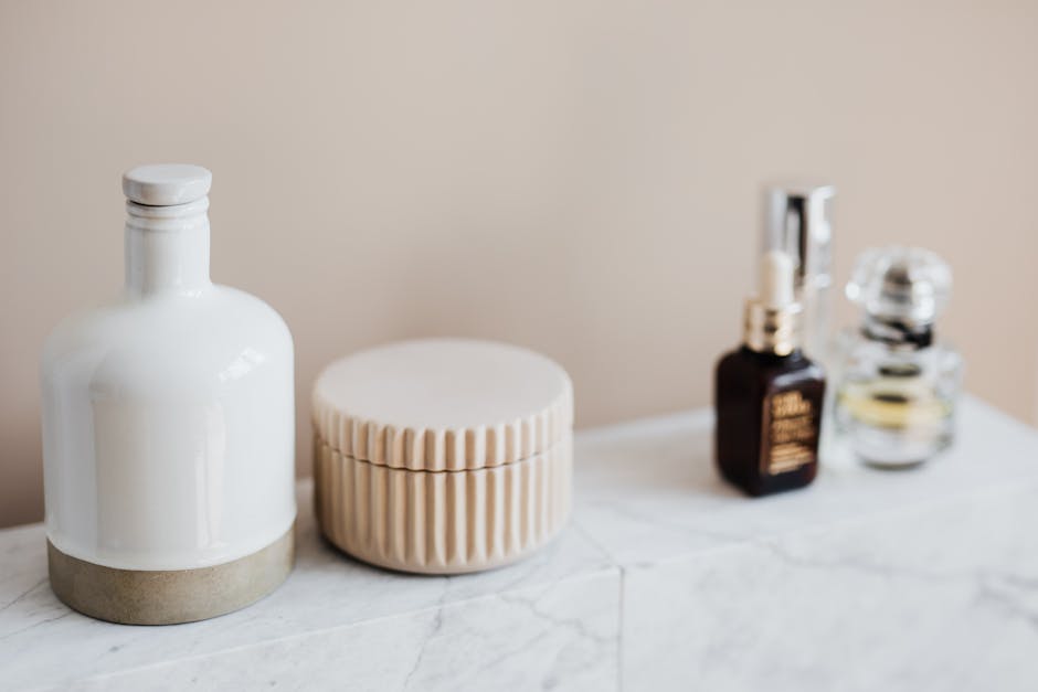 Elegant arrangement of bathroom toiletries on a marble shelf, highlighting minimalist decor.