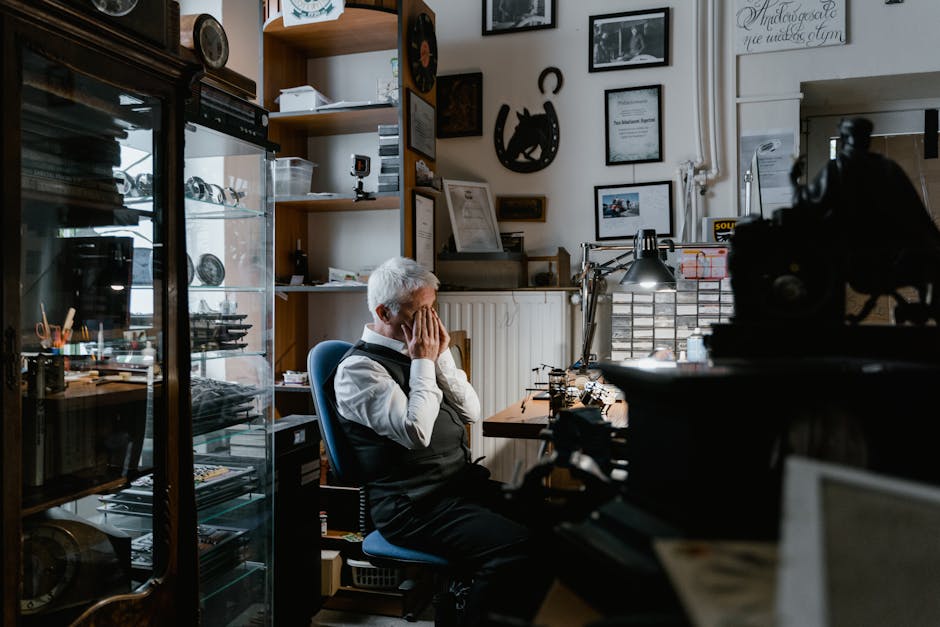 Elderly man in an office rubbing eyes in fatigue, surrounded by vintage decor.